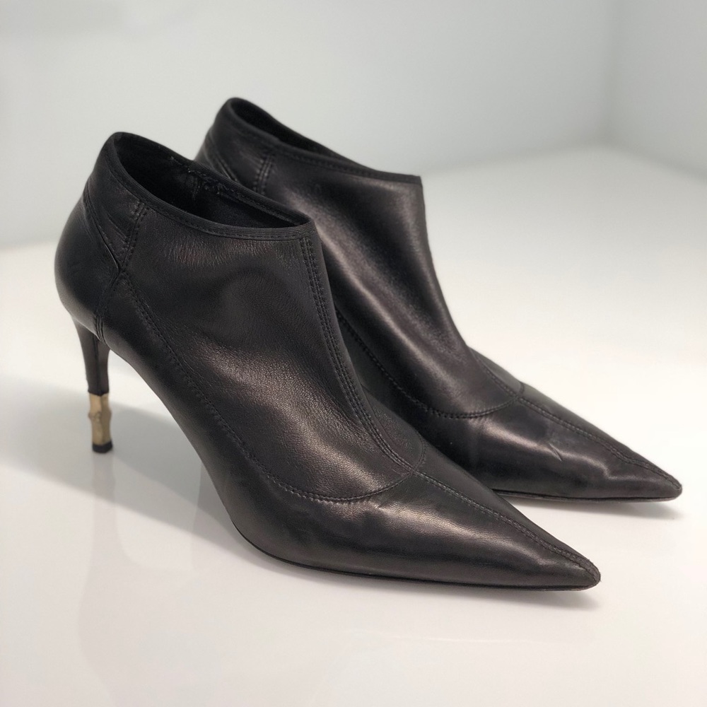 Black Gucci Booties with Gold Heel Detailing